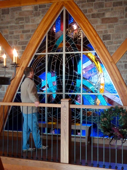 FAS stained glass window installed, shows scale, completion, and detailed woodwork.